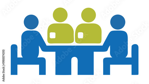 Four people engaged in a collaborative meeting around a table