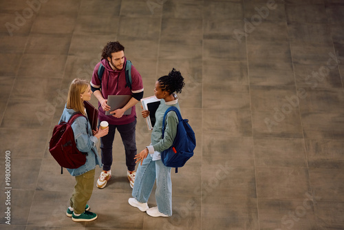 Cuadro en lienzo Adobe view of multiracial group of university students talking in hallway