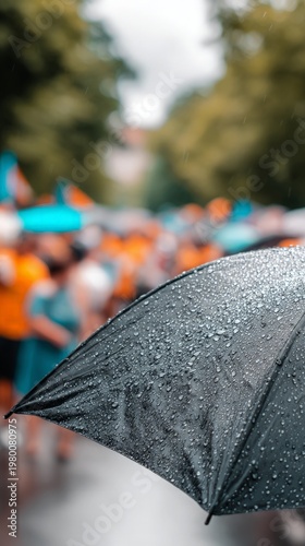 Umbrella covered in raindrops during an outdoor gathering
