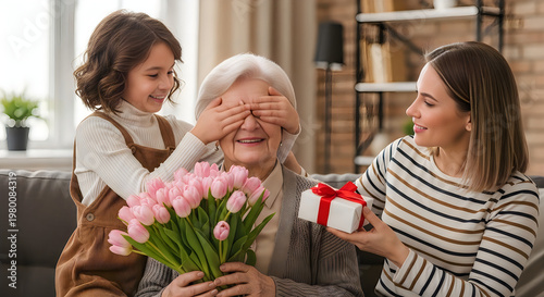 Happy multi-generational family celebrating Mother's Day with pink tulips and gift at home