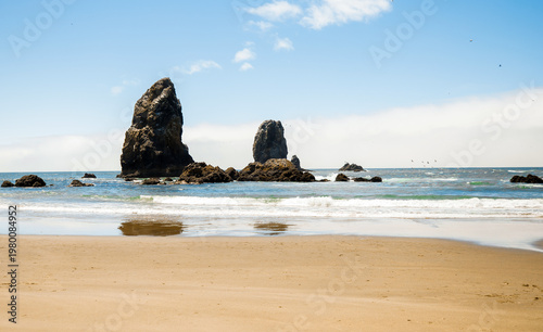 Visitors enjoying a sunny day at Cannon Beach, Oregon.