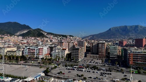 Aerial drone footage showing the Salerno coastline from above, highlighting the meeting point of city and sea.