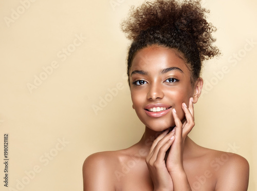 Beauty portrait of african american woman with clean healthy skin on beige background. Smiling dreamy beautiful afro hairstyle  girl.Curly afro  black hair
