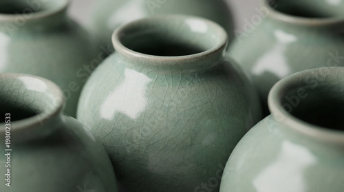 Close-up of several celadon ceramic vessels arranged closely together