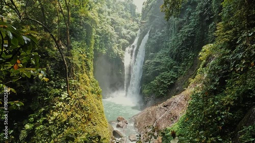stunning waterfalls in Bali surrounded by green jungles on a sunny afternoon