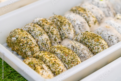 Different types of cheese displayed at a street market
