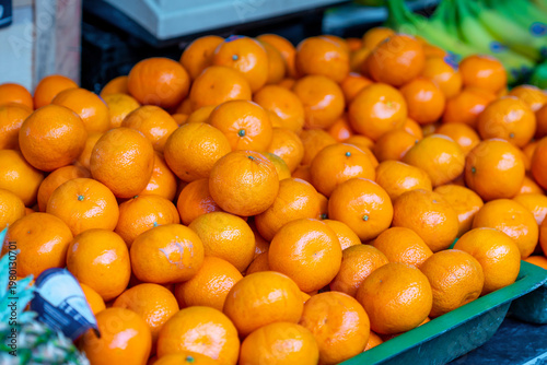 Citrus fruits displayed at the market, tangerines and other fruits