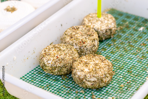 Different types of cheese displayed at a street market