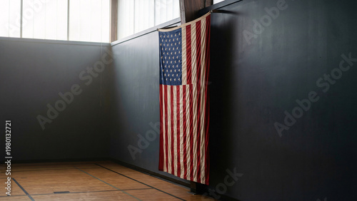 United States Flag Hanging in Quiet School Gymnasium With Charcoal Wall Copy Space, Indoor Patriotic Background, Fabric Texture, Editorial Style