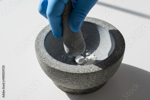 Close-up of a gloved hand using a stone mortar and pestle to crush a pill into powder. Useful for illustrating themes of pharmacy, medicine, or laboratory work, providing commercial appeal. Generative