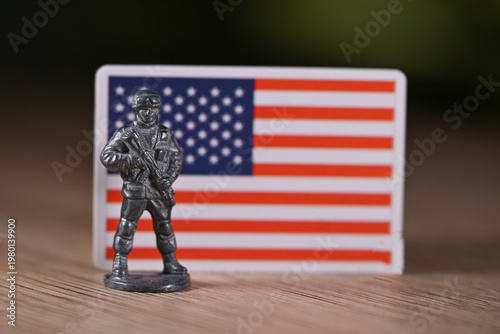 A tin soldier on the background of the flag of the United States.