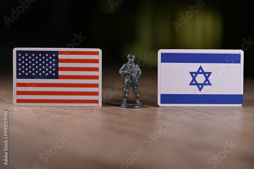 A tin soldier on the background of the flags of the United States and Israel.