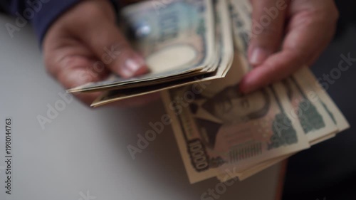 Counting JPY money Japanese Yen banknote pay shopping payment services