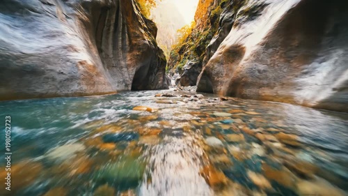 Stunning canyon river flowing through the rocks with sunlight.