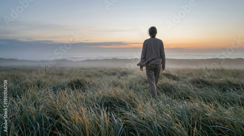 Tranquil Morning Scene With The Sun Rising Above A Grassy Meadow Casting A Warm Glow