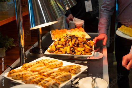 Wallpaper Mural Person serving roasted potatoes from a buffet station Torontodigital.ca