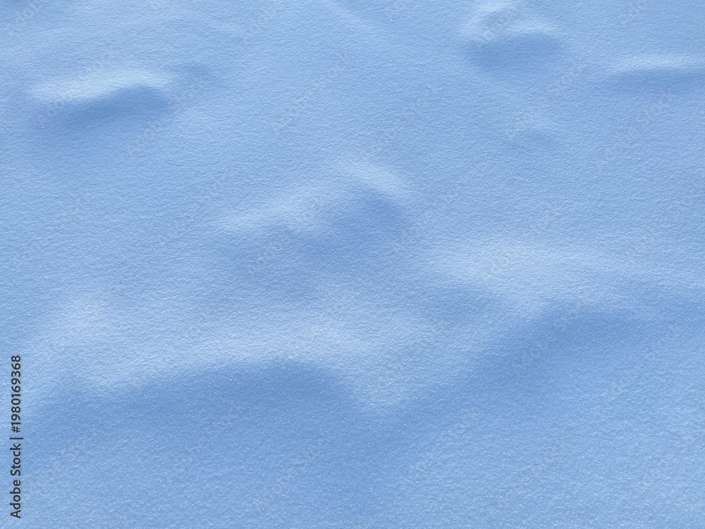Obraz premium Soft blue snow texture with gentle ridges and shadows. Perfect for winter backgrounds, calming interfaces, or serene design projects. Subtle gradient highlights add depth