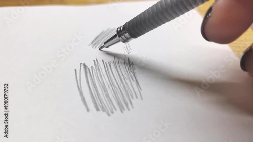 Close-up of a mechanical pencil drawing lines and strokes on paper. Creative process, sketching, learning, and artistic hobby concept. Perfect for education, school, and design themes