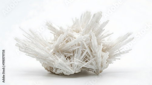 Close-up of a cluster of white needle-like crystals on a white background