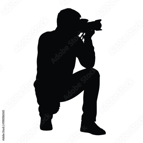 Man taking a picture with a camera in a crouched position