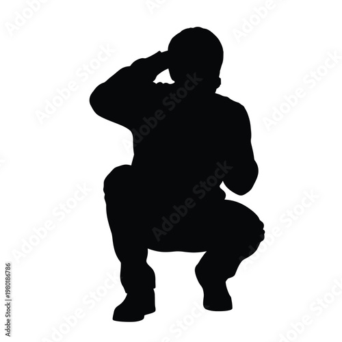 Man in a crouching position with hand on forehead