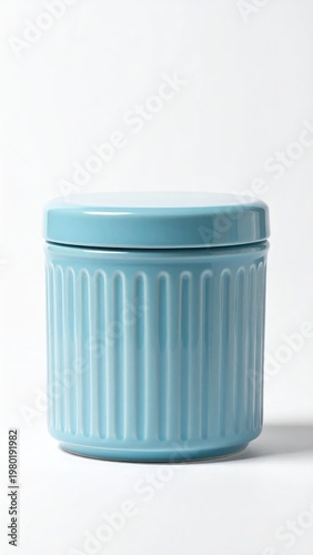 A light blue ceramic storage container with a ridged texture and a matching lid sits against a stark white background, showcasing a minimalist design.