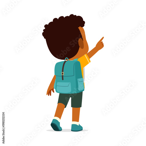 A young African American boy wearing a backpack is walking and pointing his finger upwards showing curiosity