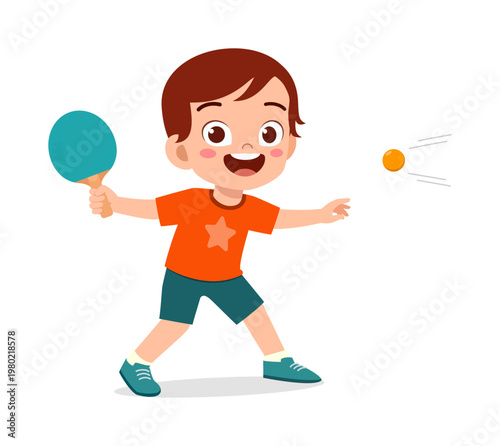 Happy cute little boy playing table tennis actively with a paddle and ball smiling cheerfully