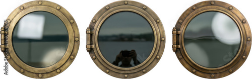 Three vintage brass porthole windows with thick metal frames and visible rivets reflecting cloudy skies and distant coastal landscapes 178 characters ship boat maritime round