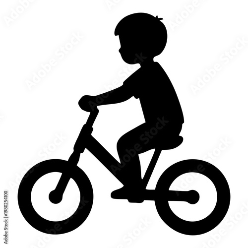 silhouette of a small child riding a balance bike