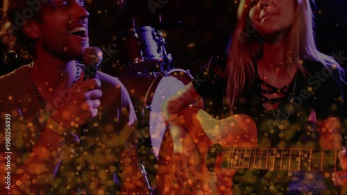 Opening guitar strum starting vocalist singing, guitarist strumming for warm gold bokeh duet
