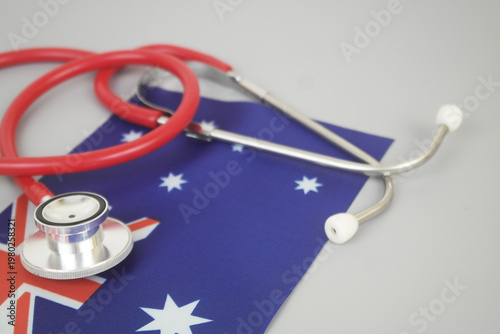 Red stethoscope on flag of Australia. Australian medicine and health insurance concept.