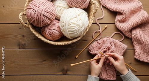 Woman knitting with pink and white yarn.
