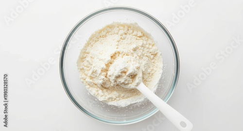 Glass bowl containing guar gum powder with plastic spoon top view texture enhancer in dairy
