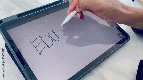Digital education concept with handwritten word Education on tablet screen using stylus pen. Modern online learning, remote study, and electronic classroom technology for creative students