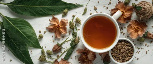 Panel kuchenny z motywem Fresh kratom leaves and flowers arranged next to a cup of herbal kratom tea on white