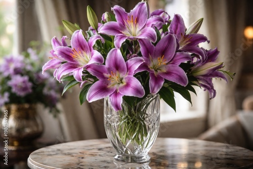 Elegant purple lily flowers blooming vibrantly in a decorative glass vase