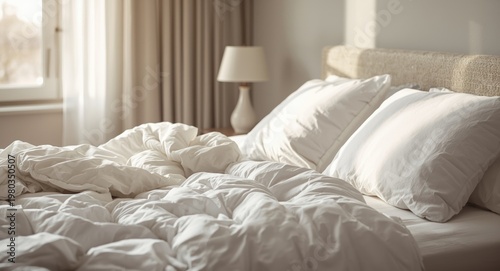 Cozy unmade bed with soft pillows and white linen in modern bedroom setting
