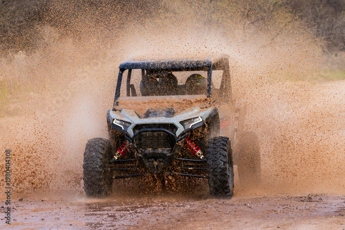 ATV Charging Through Mud Splash in High-Speed Off-Road Action