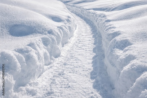 A pristine snow path carved...