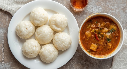 Steamed idlis served on a w...