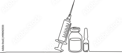 Medical equipment with syringe and vials on a clean surface