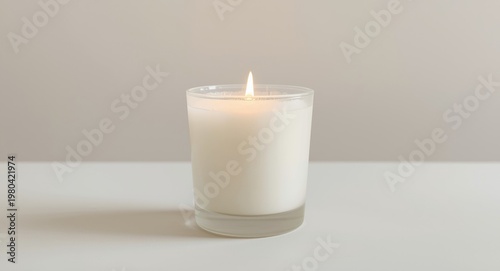 Lit white candle in frosted...