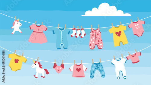 Adorable baby clothes and colorful toys hanging on clotheslines against a blue sky background with soft white clouds.
