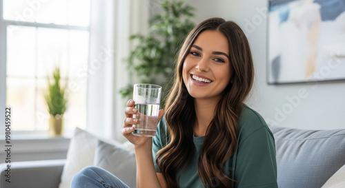 Beautiful relaxed woman holding a glass of water showing thumbs up perfect for natural wellness and body care