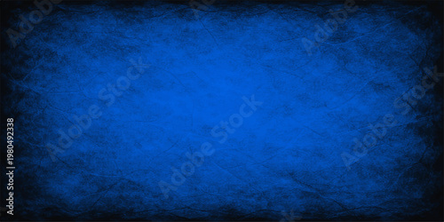 A dark vintage blue grunge wall texture with a rough aged paint pattern and blank canvas copy space makes a textured retro film backdrop for paper art design