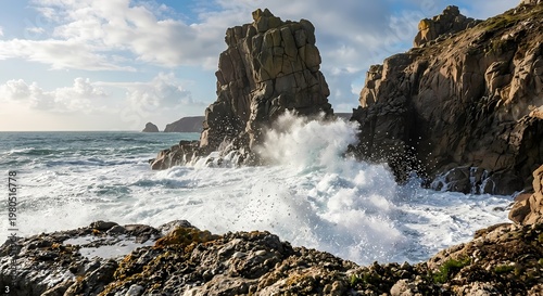 Rocky cliffs dominate the coastal scene as waves crash against them with force. 