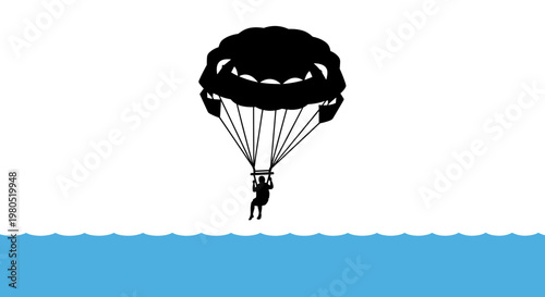 Man parachuting over the ocean.