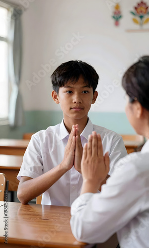 Wallpaper Mural Young Asian boy performing greeting gesture with teacher in classroom   Torontodigital.ca