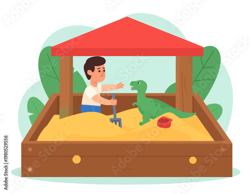 A young boy playing with a toy dinosaur and a rake in a wooden sandbox with a red roof.